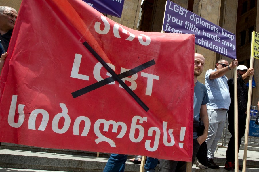 Georgian far right parties and their supporters hold a banner that reads, "No to LGBT darkness," in front of parliament during a rally against Pride Week in Tbilisi, Georgia, in 2022.