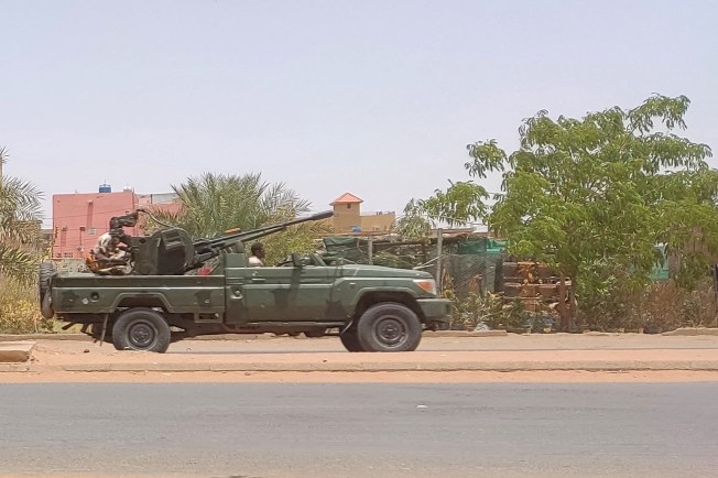 Fighters of the paramilitary Rapid Support Forces (RSF) drive an armoured vehicle in Khartoum in 2023.