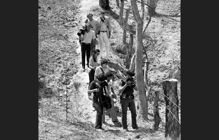 In this March 18, 1982 photo, television cameramen photograph blood-soaked, bullet-ridden clothes believed to belong to four Dutch journalists killed in a wooded area near this village in the province of Chalatenango, in El Salvador. Jan Kuiper, Koos Koster, Hans ter Laag and Joop Willemsen were killed in 1982 while on assignment for IKON, a Dutch public TV broadcaster. (AP Photo/P.W. Hamilton)