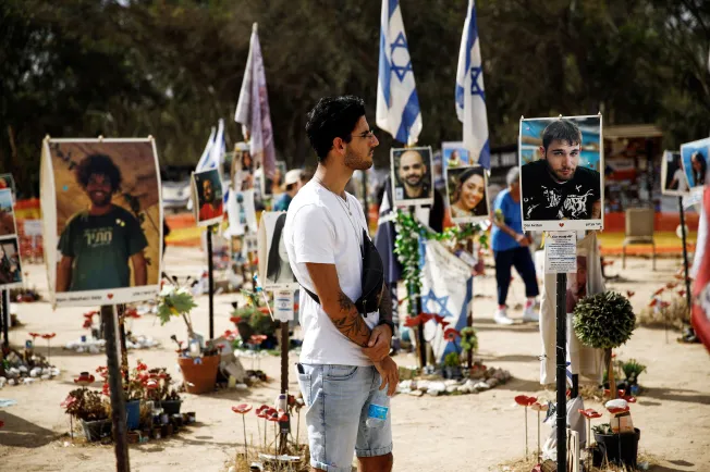 Documentary photographer Shye Klein, 27, who survived Hamas' deadly October 7, 2023, raid on an Israeli music festival, looks at a portrait of a festival-goer he met during the event. Klein returned to the festival site on September 17, 2024, as part of his project to document survivors' stories. Hamas killed an estimated 380 people in the attack. (Photo: Reuters/Shir Torem)