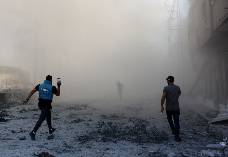 A journalist and others rush toward the scene of an explosion following an Israeli strike on the outskirts of Gaza City, on September 1, 2024. (Photo: AFP/Omar Al-Qattaa)