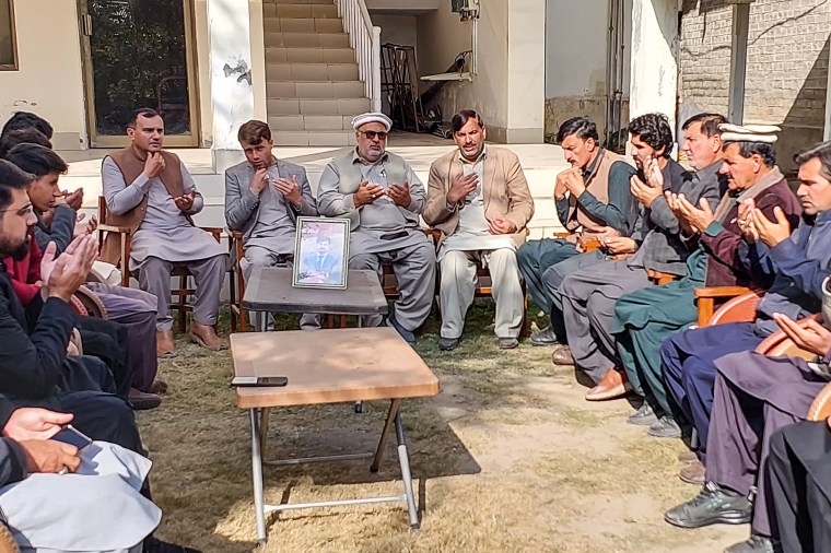 Local journalists pray for fellow journalist Janan Hussain, who was killed in a shooting in Kurram district on November 20, 2024. (Photo: AFP/Dilawer Khan)