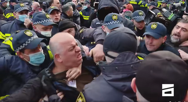 Officers grab Sergi Baramidze, a camera operator for pro-opposition broadcaster Mtavari Arkhi, after he filmed police during a protest contesting the results of Georgia’s parliamentary election in Tbilisi on November 19, 2024. (Photo: Facebook/Mtavari Arkhi)