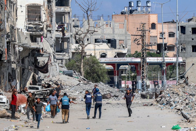 Journalists film while standing before destroyed buildings in the Jabalia camp for Palestinian refugees in the northern Gaza on October 9, 2024. (Photo: AFP/Omar Al-Qattaa)