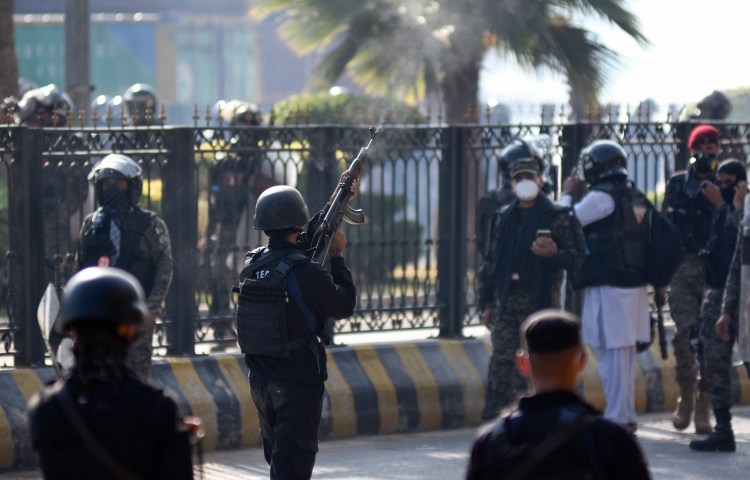 A police officer fires warning shots in the air during clashes with supporters of imprisoned former Prime Minister Imran Khan's Tehreek-e-Insaf party in Islamabad, Pakistan, on November 26, 2024. (Photo: AP/W.K. Yousufzai)