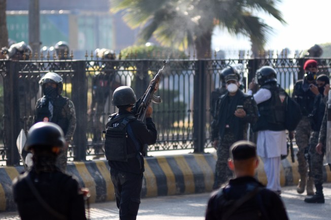 A police officer fires warning shots in the air during clashes with supporters of imprisoned former Prime Minister Imran Khan's Tehreek-e-Insaf party in Islamabad, Pakistan, on November 26, 2024. (Photo: AP/W.K. Yousufzai)