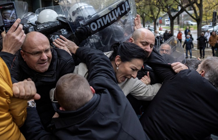 Serbian members of parliament Marinika Tepic and Borislav Novakovic, and other opposition representatives scuffle with police officers during a protest over the fatal collapse of a roof at a railway station, demanding that those responsible for the disaster be brought to justice, in front of a court house in Novi Sad, Serbia, November 21, 2024. REUTERS/Marko Djurica TPX IMAGES OF THE DAY - RC2I9BAWRSBX