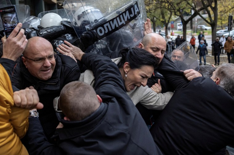 Serbian members of parliament Marinika Tepic and Borislav Novakovic, and other opposition representatives scuffle with police officers during a protest over the fatal collapse of a roof at a railway station, demanding that those responsible for the disaster be brought to justice, in front of a court house in Novi Sad, Serbia, November 21, 2024. REUTERS/Marko Djurica TPX IMAGES OF THE DAY - RC2I9BAWRSBX