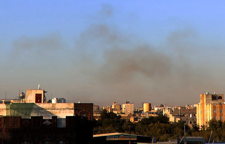 Smoke rises from the area around the International Airport following an Israeli airstrike, as seen from Sanaa, Yemen, on December 26, 2024. Separately, the Yemeni branch of Al-Qaeda announced on December 28 the execution of 11 individuals, including Yemeni journalist Mohamed Al-Maqri. (Photo: AP/Osamah Abdulrahman)