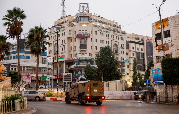 A military vehicle moves in a street outside the building where the Al Jazeera office is located, in Ramallah, in the Israeli-occupied West Bank, September 22, 2024. REUTERS/Mohammed Torokman - RC2F5AA82Z43