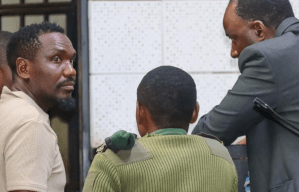 Journalist Blessed Mhlanga (left) in the capital's Harare Magistrates Court with his lawyer Chris Mhike (right) on February 25.
