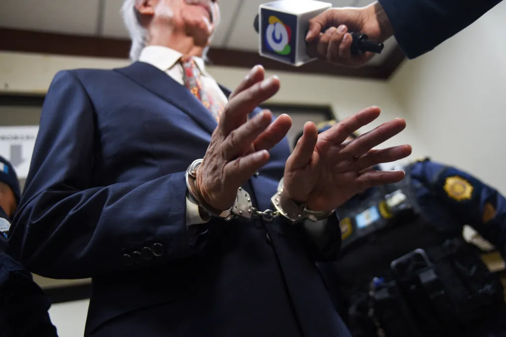 Journalist Jose Ruben Zamora Marroquin is pictured in handcuffs as he speaks to the media in Guatemala City after a judge revoked his house arrest March 10, 2025. (Reuters/Cristina Chiquin)