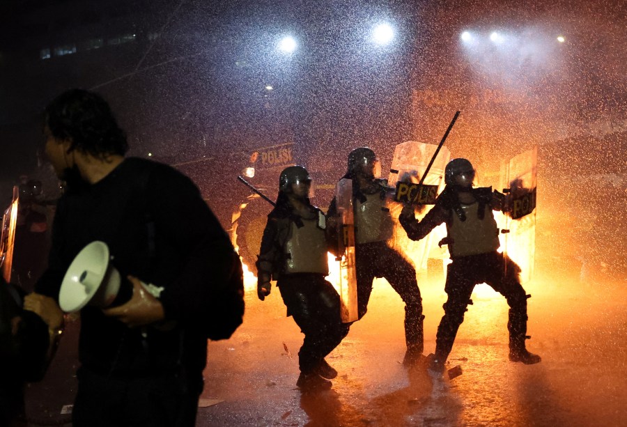 Police in riot gear during a protest outside the Indonesian Parliament against revisions to the country's military law in the capital Jakarta on March 27.