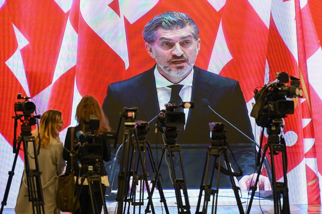 Journalists in a press room watch Mikheil Kavelashvili, Georgia's newly elected president and leader of the Georgian Dream party, take the oath of office during his swearing-in ceremony at the parliament building in Tbilisi, on December 29, 2024. (Photo: AFP/Shlamov)
