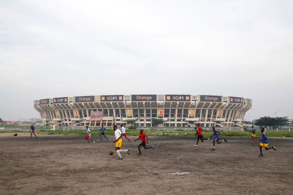 Youth play soccer in front of the Stade Des Martyrs stadium in Kinshasa, Democratic Republic of Congo, January 3, 2019. REUTERS/Baz Ratner