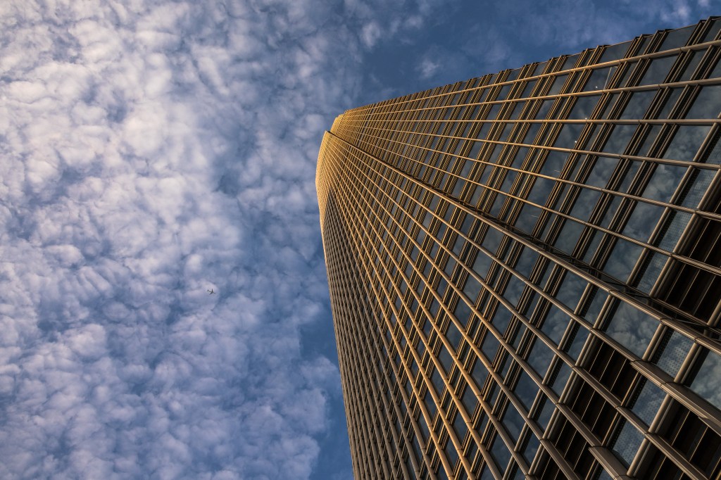 A plane flies over the Two International Finance Centre in Hong Kong in 2024.