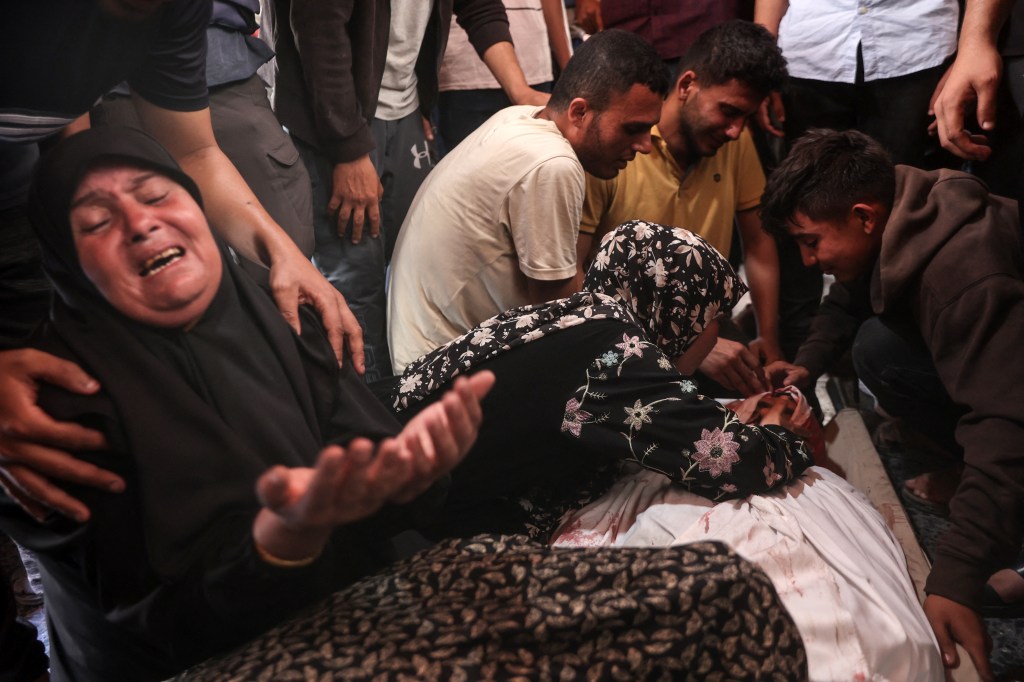 Mourners react over the body of one of three Palestinian journalists reportedly killed in Israeli bombardment in the yard of the Ahli Arab Hospital, in Gaza City on June 5, 2025.