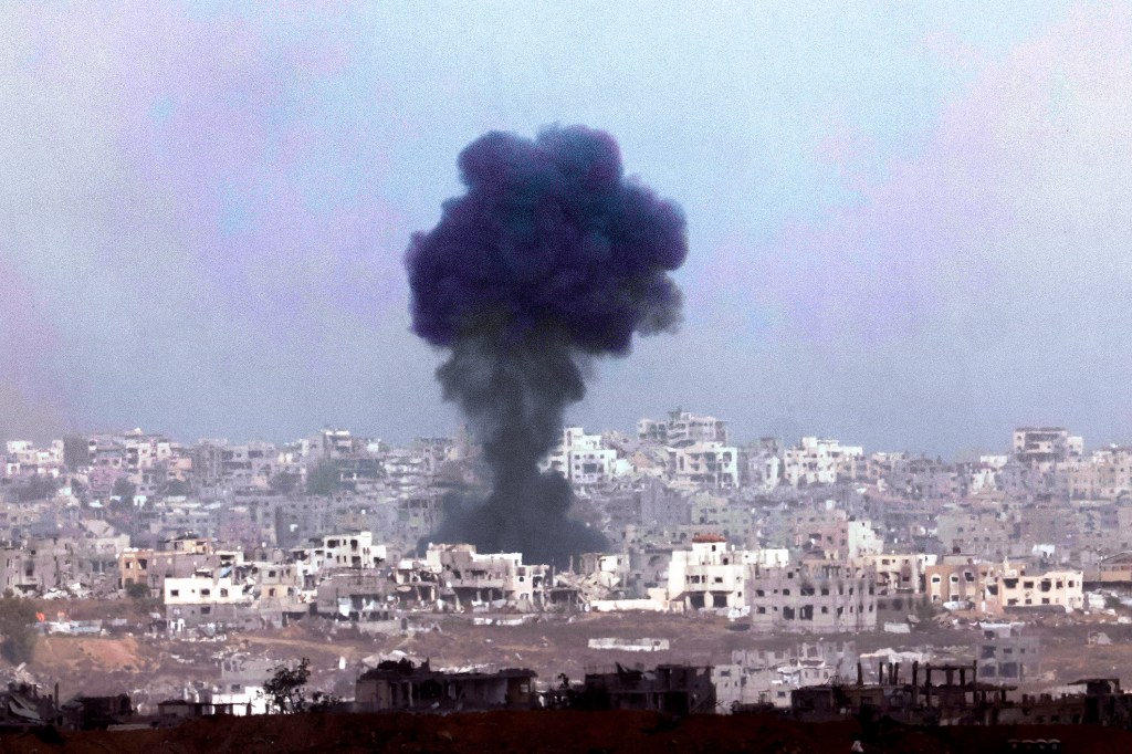 In this photograph taken from southern Israel, smoke billows across destroyed buildings in the Gaza Strip during an Israeli bombing on May, 27, 2025. (Photo: AFP/Jack Guez)