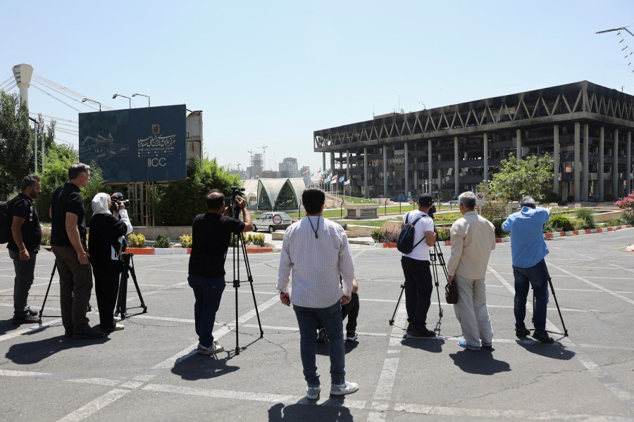 Journalists filming in the aftermath of an Israeli strike on Iran's state TV broadcaster's building in Tehran on June 19.