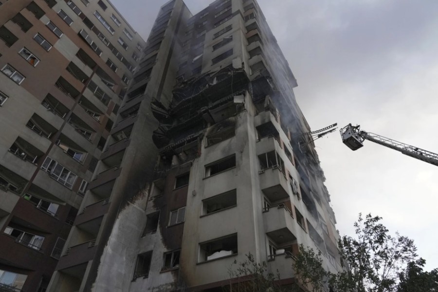 A rescue crane rises next to a residential building struck in Israeli attacks on the Iranian capital Tehran on June 13, 2025.