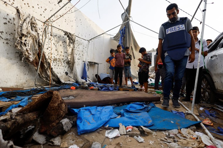 A journalist inspects the damage the day after an Israeli strike on a tent near Gaza City's Al-Shifa Hospital on August 10, 2025, in which four Al Jazeera journalists were killed.