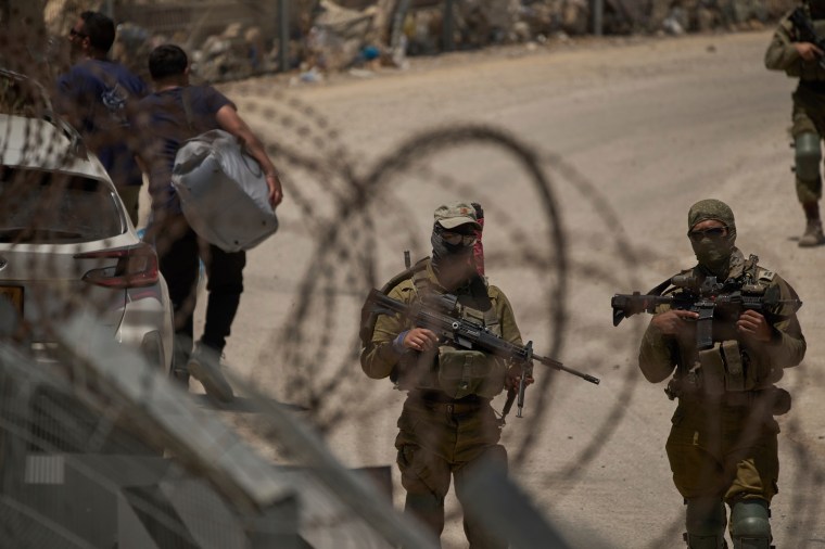 Israeli soldiers guard the Israeli-Syrian border, in the Israeli-controlled Golan Heights town of Majdal Shams, on July 17, 2025. (Photo: AP/Leo Correa)
