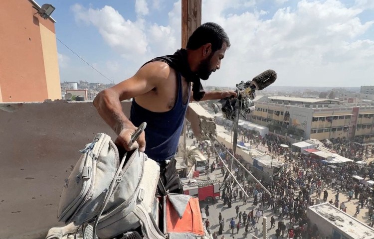 A man holds the equipment used by Palestinian camera operator Hussam Al-Masri, a contractor for Reuters, at the site where he was killed along with other journalists and people in Israeli strikes on Nasser hospital, in Khan Yunis on, August 25, 2025. (Photo: Reuters/Hatem Khaled)