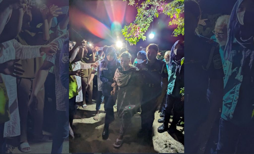 Farzana Rupa is escorted in handcuffs to her mother's funeral on June 11.