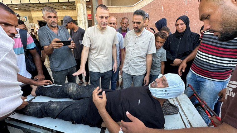 Hatem Khaled, a photographer who contributes to Reuters, is assisted after being wounded in Israeli strikes on Nasser Hospital that killed five journalists on August 25, 2025. (Photo: Reuters/Ramadan Abed)