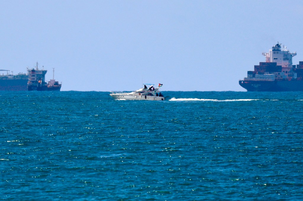 This photo shows a boat from the Global Sumud Flotilla, one of the earlier aid convoys intercepted by Israeli forces in the Mediterranean sea off the Gaza Strip waters, being escorted towards the southern port of Ashdod on October 2, 2025.