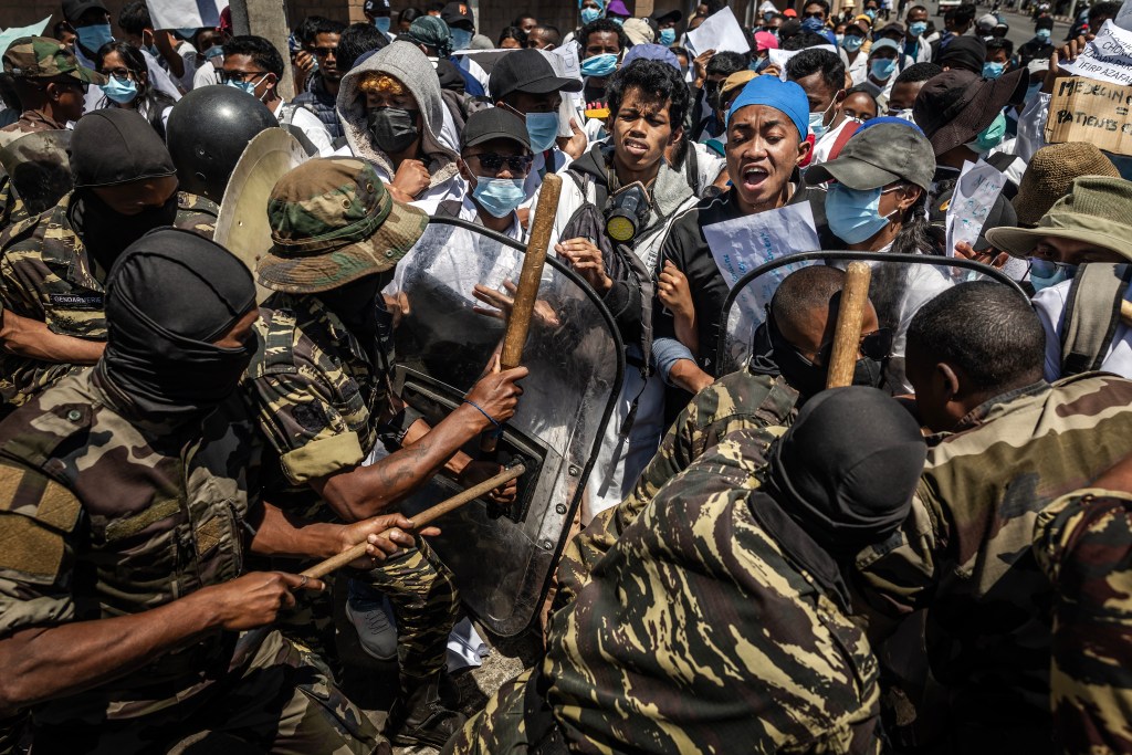Medical students are pushed back by Malagasy security forces during a demonstration calling for improved healthcare and reform in the capital, Antananarivo, on October 7.