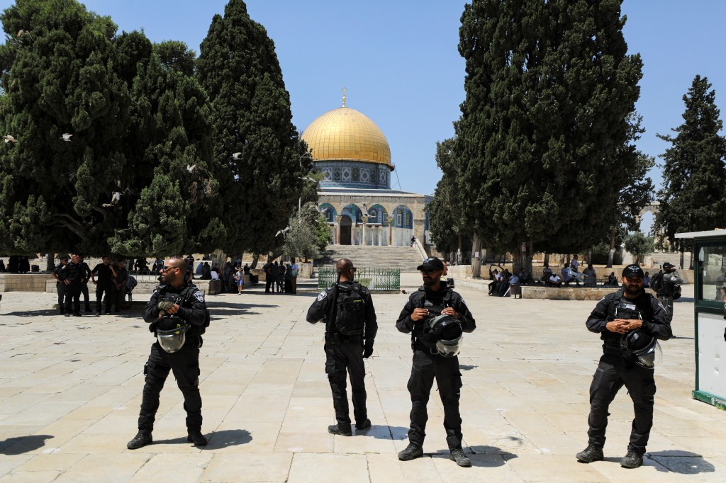 The Dome of the Rock is seen behind Israeli security forces after clashes between Israeli police and Palestinians at al-Aqsa Mosque over visits by Jews to the compound known to Muslims as Noble Sanctuary and to Jews as Temple Mount, in Jerusalem's Old City in 2021.