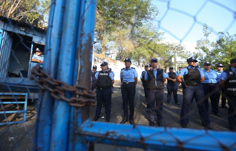 Nicaraguan police face protesters outside a notorious detention center in 2018.