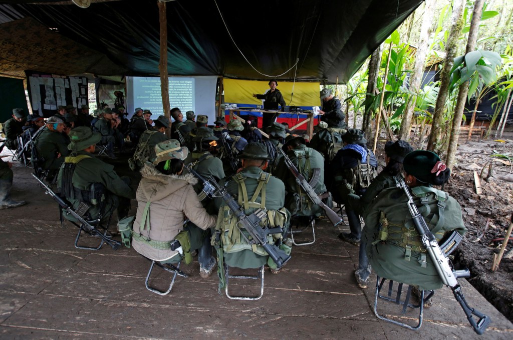 Members of the 51st Front of the Revolutionary Armed Forces of Colombia (FARC) listen to a lecture on the peace process between the Colombian government and their force at a camp in Cordillera Oriental, Colombia, August 16, 2016. Picture taken August 16, 2016. REUTERS/John Vizcaino