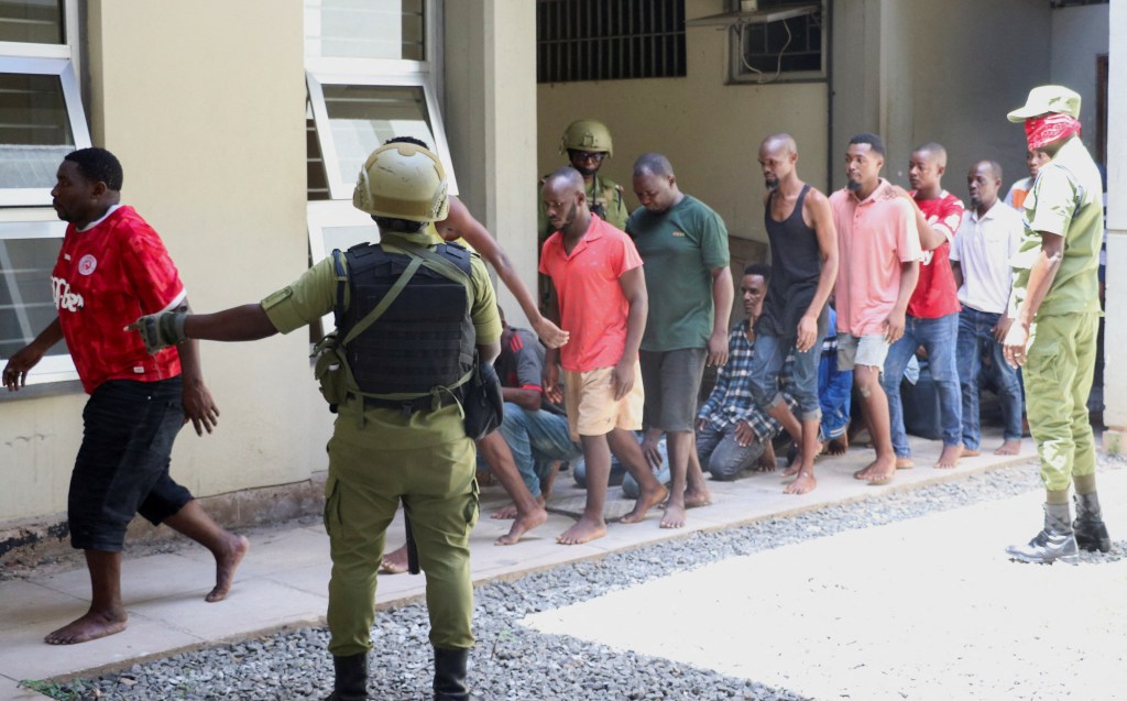 Tanzanians charged with treason for alleged involvement in violent protests arrive at court in Dar es Salaam on November 7, 2025.