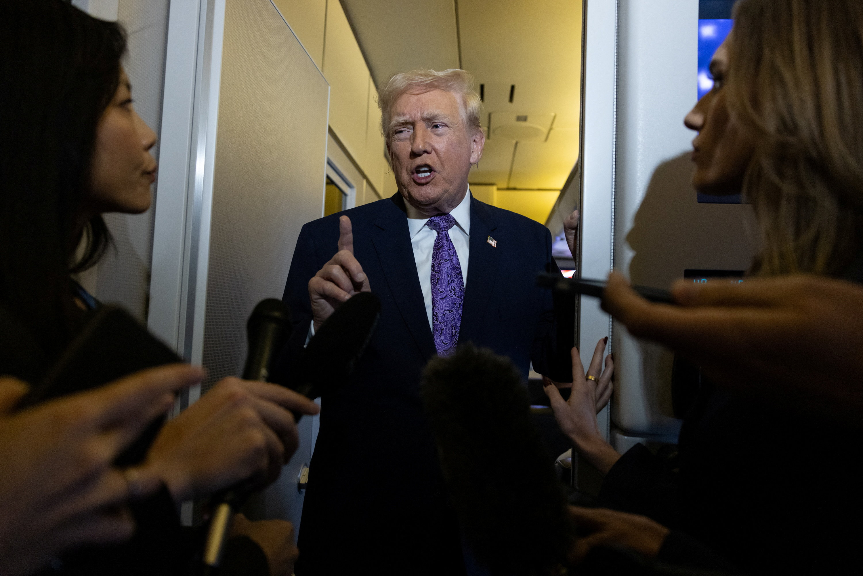 U.S. President Donald Trump speaks to reporters during travel to Washington, D.C., from Palm Beach International Airport, Florida, U.S., November 30, 2025. REUTERS/Anna Rose Layden