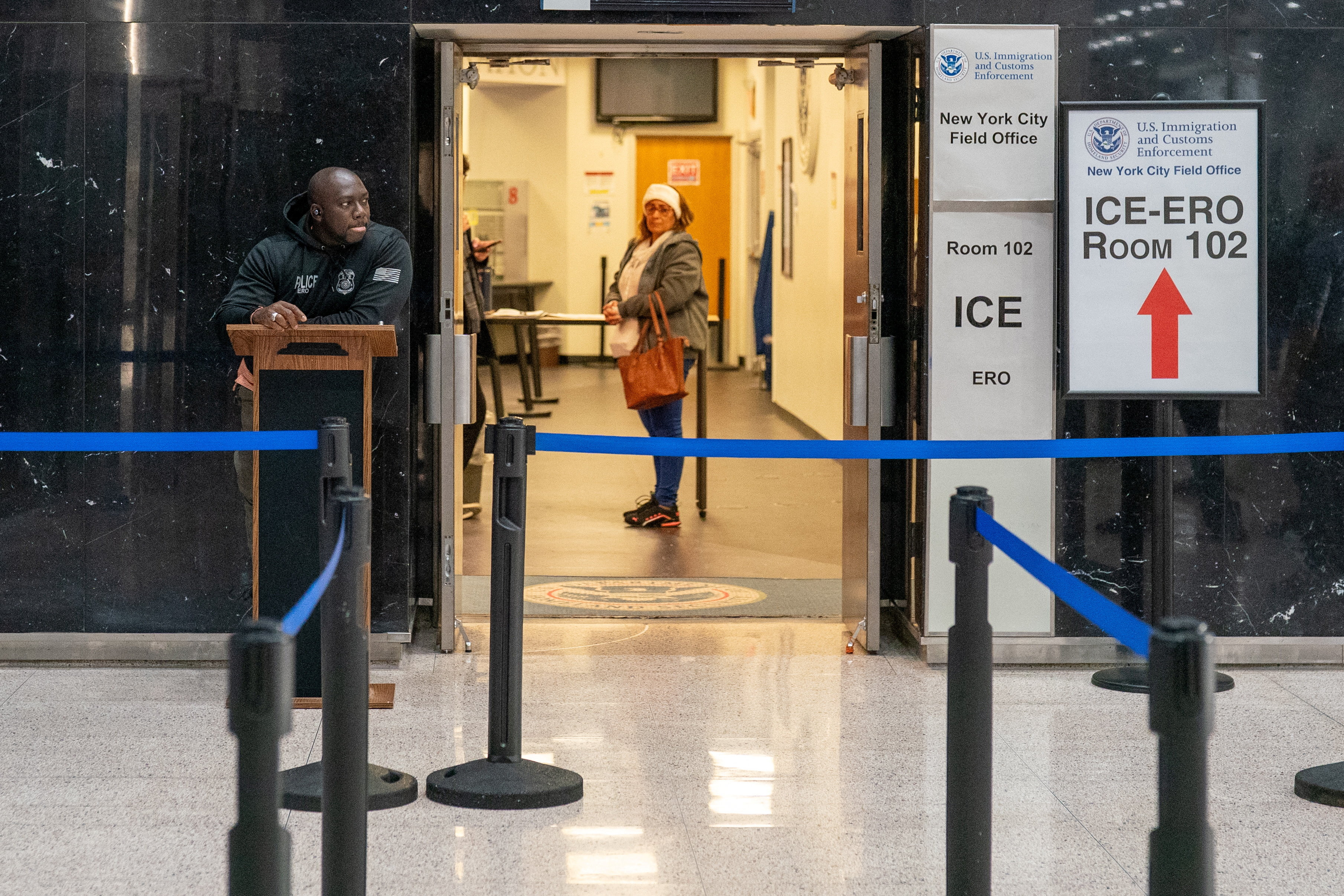 A woman waits at an Immigration and Customs Enforcement ICE) check-in office at the U.S. immigration court in Manhattan, New York City, U.S., December 18, 2025. REUTERS/David 'Dee' Delgado