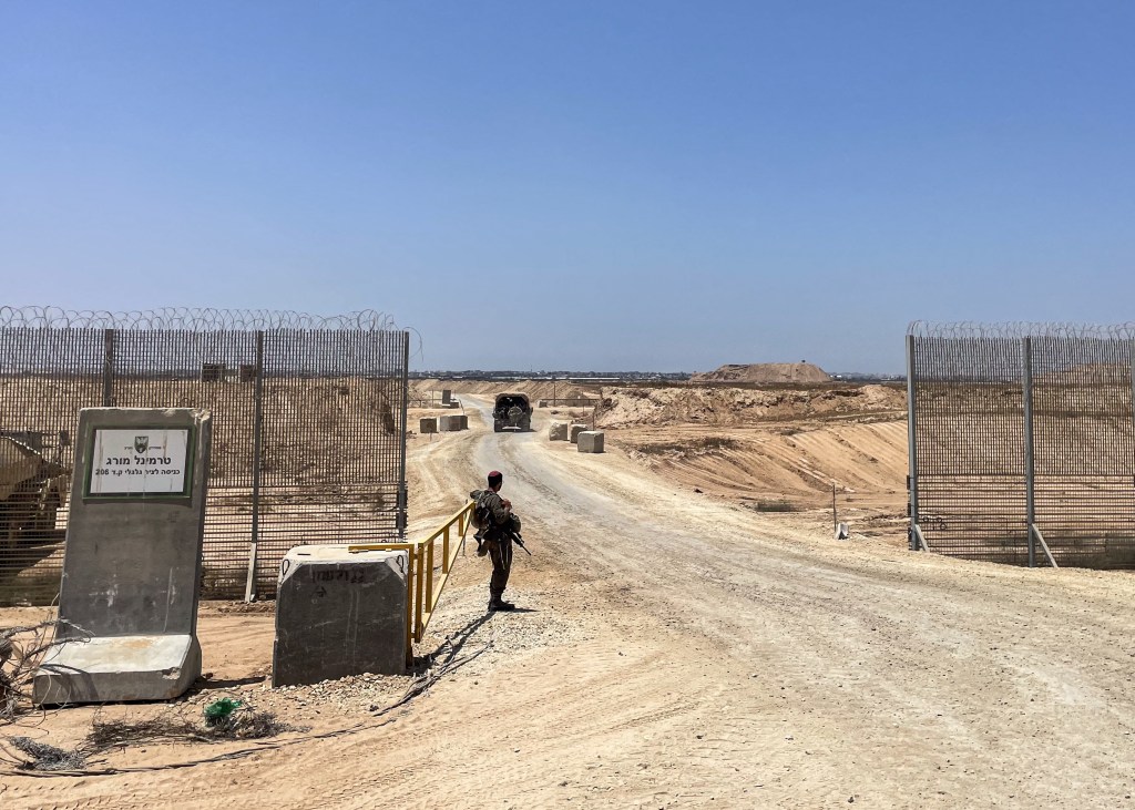 This picture taken on June 8, 2025, shows Israeli military vehicles as they drive through the entrance to the so-called Morag Corridor, during a controlled embed organised by the Israeli military in Khan Yunis in the Gaza Strip.