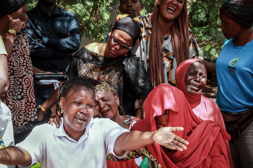 Mourners react as pay their final respects to a Tanzanian who was killed amid unrest following the presidential election, in Mwanza on November 6.