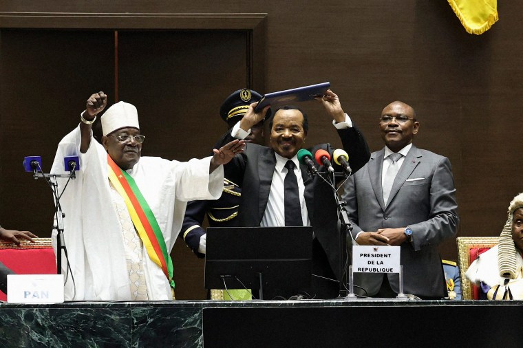 Cameroon President Paul Biya (center) gestures as he celebrates his inauguration at the National Assembly in Yaounde on November 6, 2025.