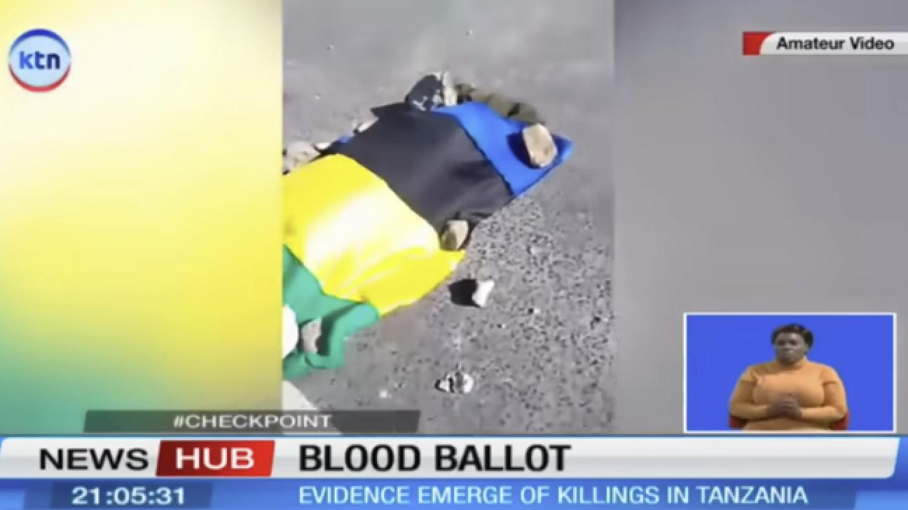 A Kenyan television channel reports on killings in Tanzania, with an image of a body on a street draped in the colours of the Tanzanian flag, on November 2.