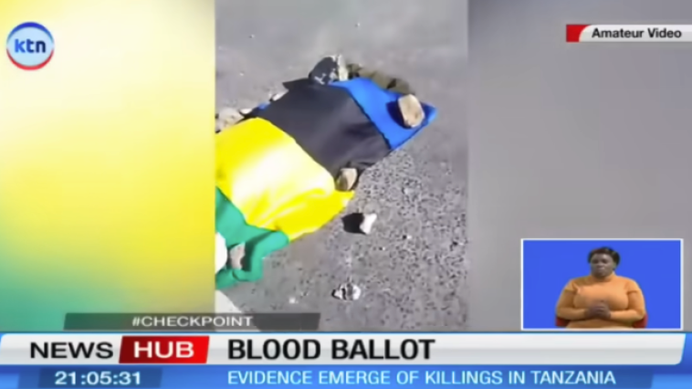 A Kenyan television channel reports on killings in Tanzania, with an image of a body on a street draped in the colours of the Tanzanian flag, on November 2.