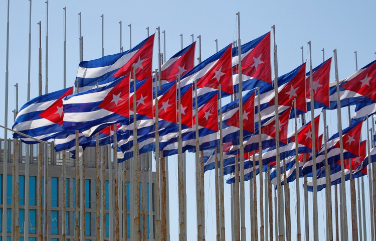 Cuban flags fly beside the Interests Section Office of the United States (USINT), in Havana two days after the 57th anniversary of the start of the Cuban revolution July 28, 2010. REUTERS/Desmond Boylan (CUBA - Tags: POLITICS)