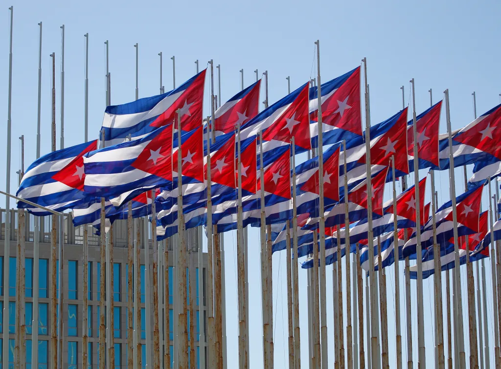 Cuban flags fly beside the Interests Section Office of the United States (USINT), in Havana two days after the 57th anniversary of the start of the Cuban revolution July 28, 2010. REUTERS/Desmond Boylan (CUBA - Tags: POLITICS)
