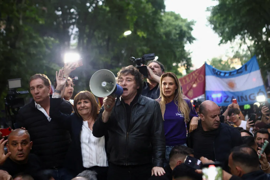 Argentina's President Javier Milei uses a megaphone as lawmaker Diego Santilli and Security Minister Patricia Bullrich look on beside him during a La Libertad Avanza party rally ahead of the October 26 midterm elections, seen as crucial for Milei's administration after U.S. President Donald Trump warned that future support for Argentina would depend on Milei's party performing well in the vote, in Tres de Febrero, on the outskirts of Buenos Aires, Argentina, October 17, 2025. REUTERS/Matias Baglietto