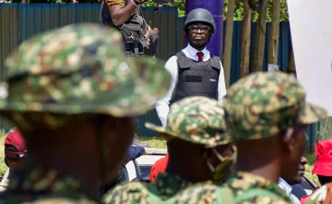 Ugandan presidential candidate Robert Kyagulanyi, also known as Bobi Wine, of the National Unity Platform (NUP) party, wears a helmet and a bulletproof vest, during a December campaign rally.