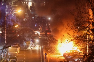 Cars burn in a street during a protest over the collapse of the currency's value, in Tehran, Iran, January 8, 2026.