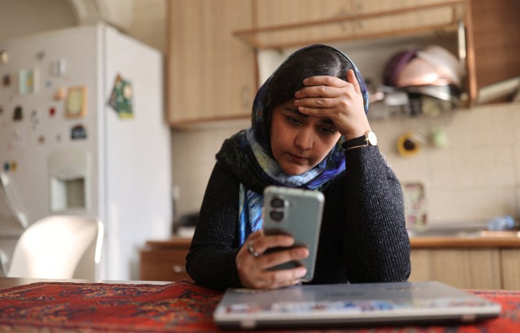 A woman in Tehran looks at her phone, after a nationwide internet shutdown began on January 8.