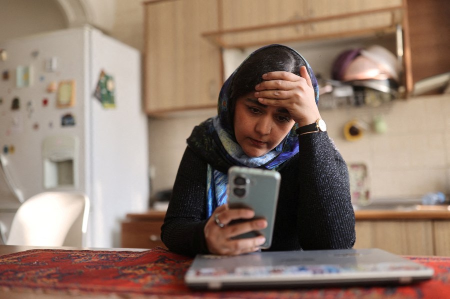 A woman in Tehran looks at her phone, after a nationwide internet shutdown began on January 8.