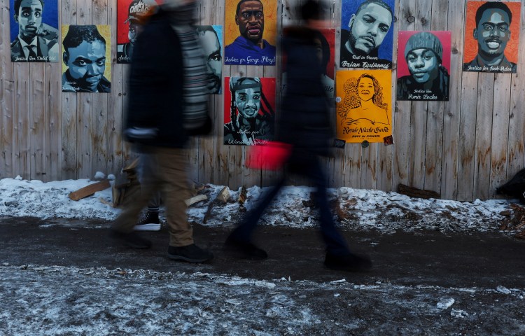 Portraits of individuals killed in incidents with authorities, including George Floyd, Philando Castile, Amir Locke, Daunte Wright, Winston Smith, Isak Aden, and more recently Renee Nicole Good, are displayed on a fence near the site where Good was fatally shot by a U.S. Immigration and Customs Enforcement (ICE) agent on January 7, as people walk by in Minneapolis, Minnesota, U.S., January 29, 2026. REUTERS/Shannon Stapleton